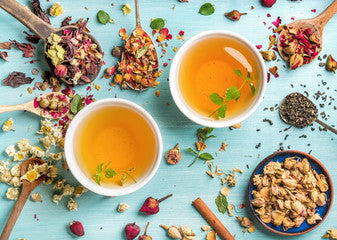 tea with botanicals on blue background