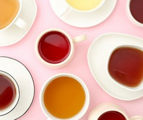 different types of tea on a pink background