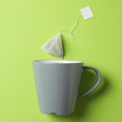 Teabag going into a cup