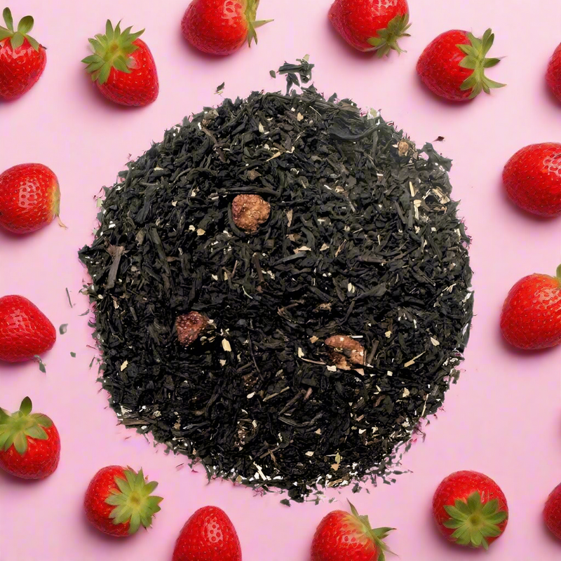 Black tea with strawberries in background 